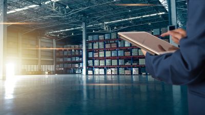 Person in warehouse holding a tablet