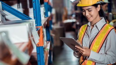 Woman in hard hat doing inspection and auditing