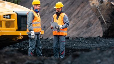 Two men in hard hats standing in a construction site