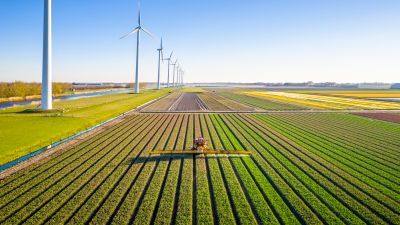 Farm equipment by windmills in the Netherlands